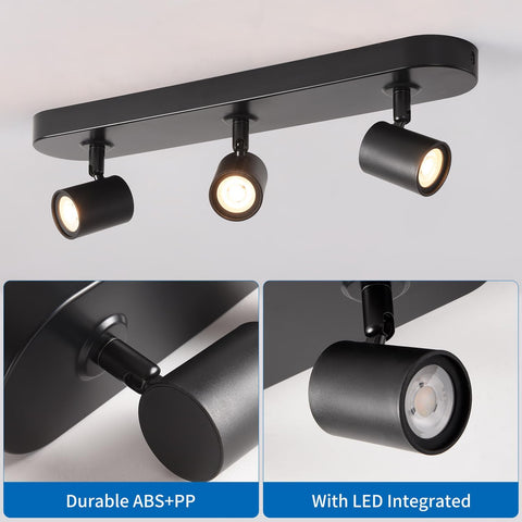 Black ceiling light fixture with three adjustable lights on a gray background