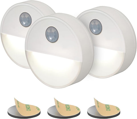 Three motion sensor lights with adhesive pads on a white background