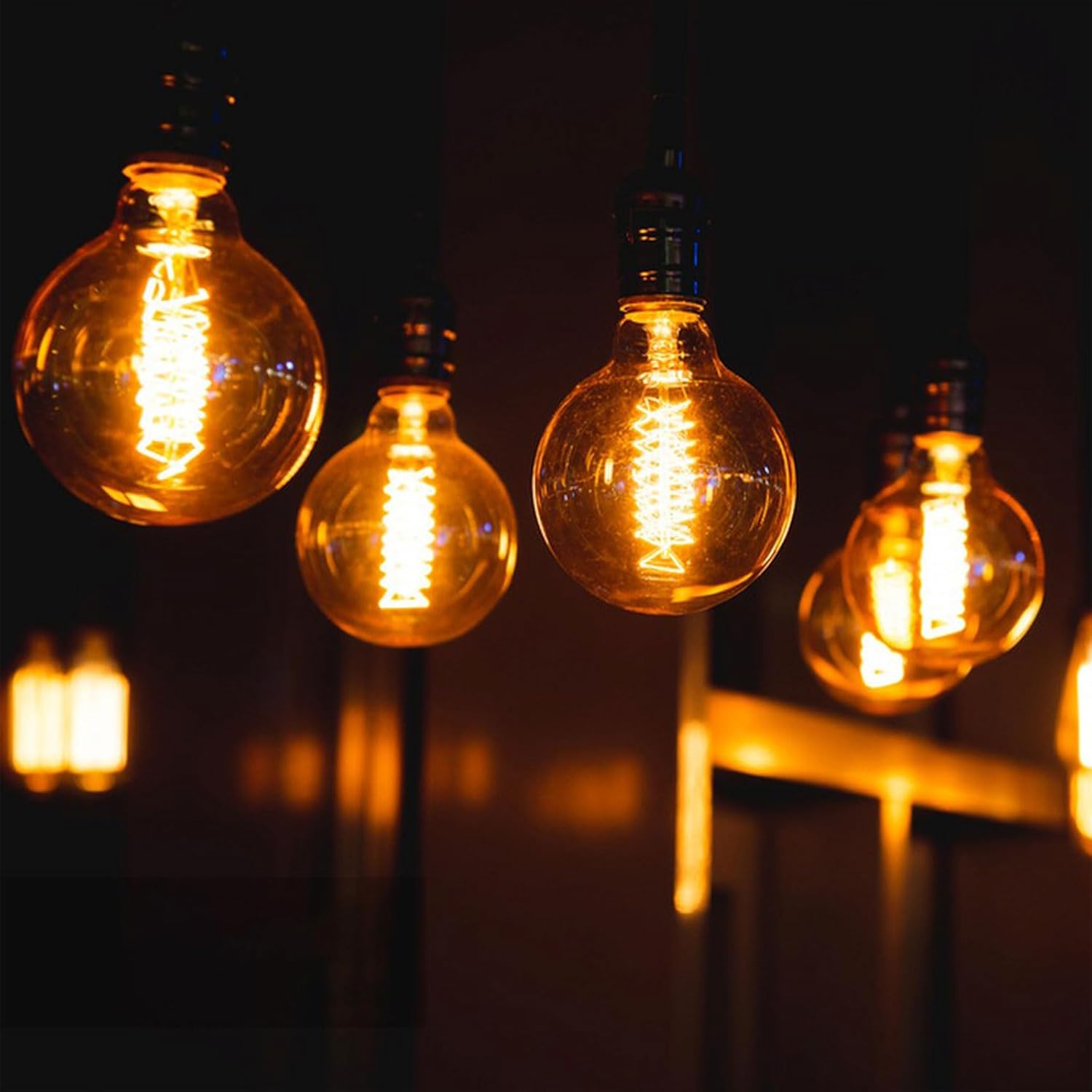 Vintage-style light bulbs glowing warmly against a dark background
