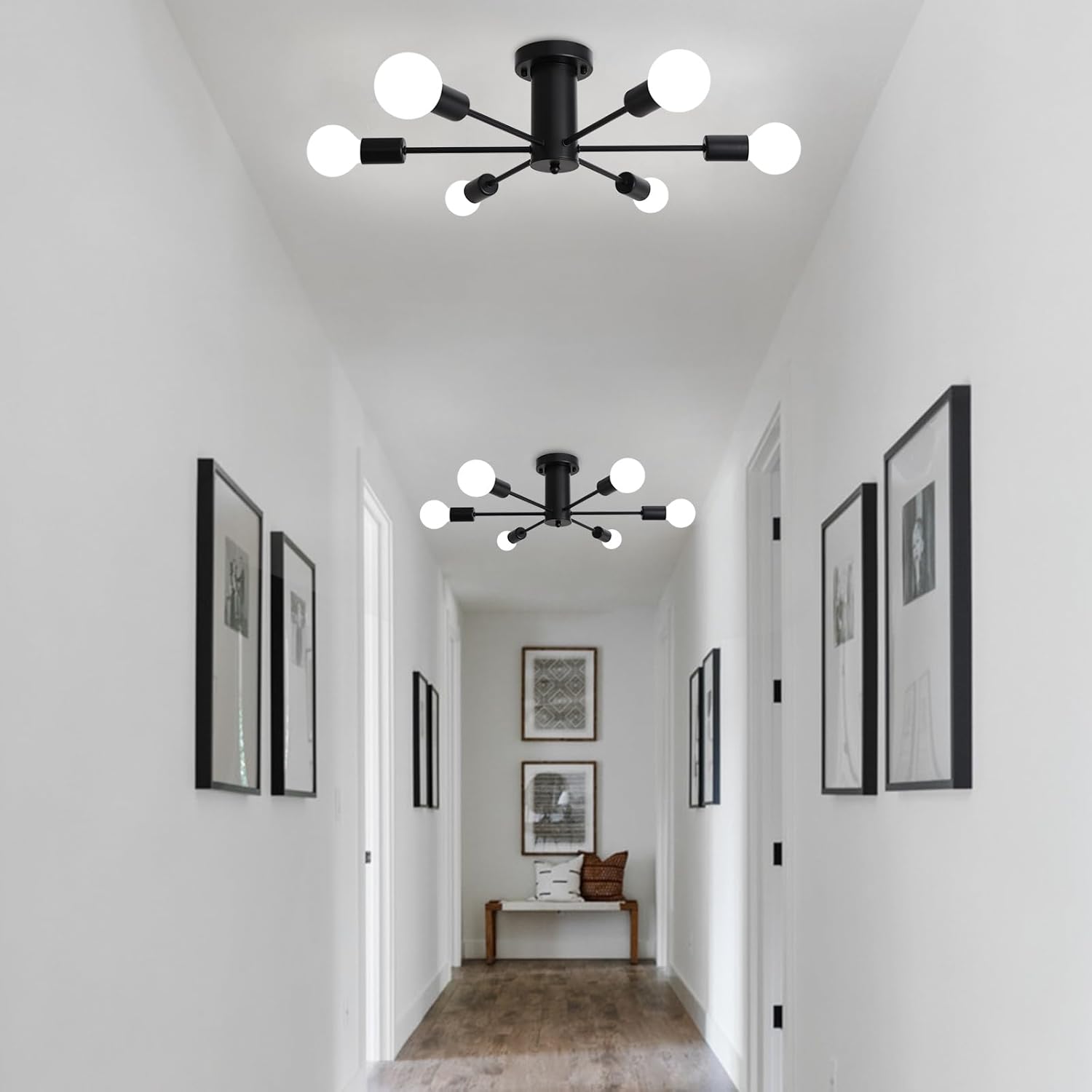 Modern black ceiling light fixture in a hallway with white walls and framed pictures.
