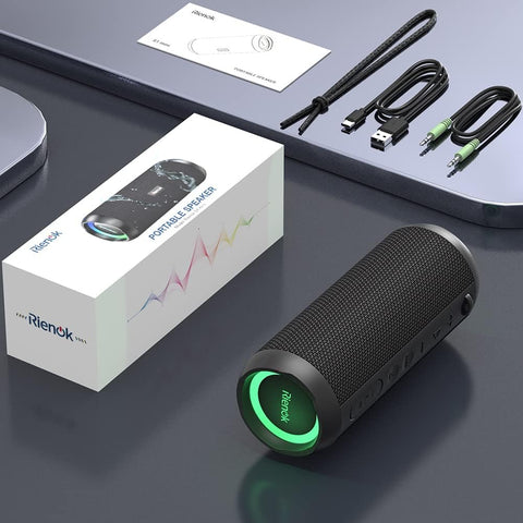 Rienok portable speaker with accessories on a dark surface
