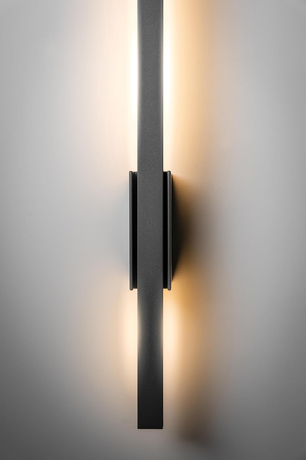 Modern wall-mounted light fixture on a neutral background