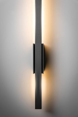 Modern wall-mounted light fixture on a neutral background
