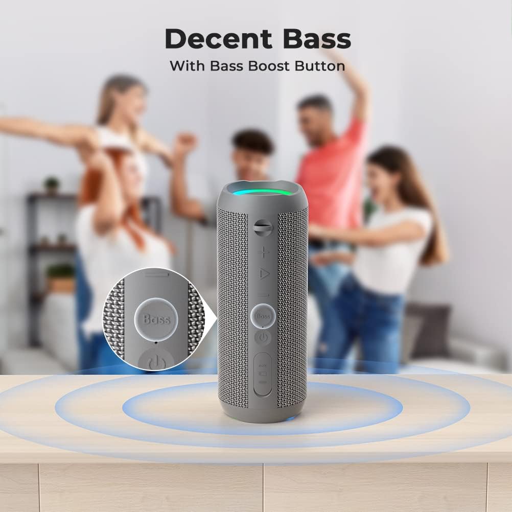 Gray speaker with Bass Boost Button on a wooden surface, people dancing in the background.