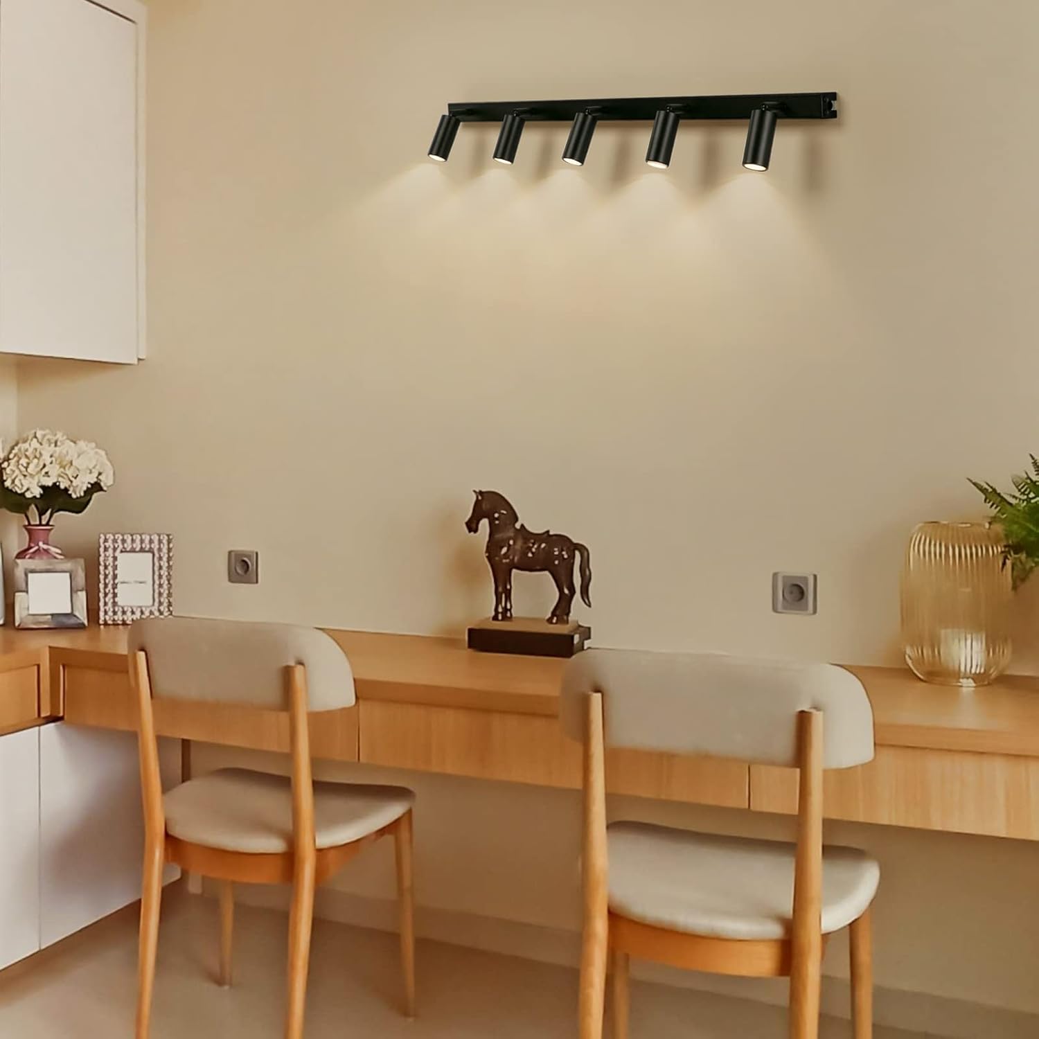 Dining area with wooden table, chairs, and wall-mounted light fixture.