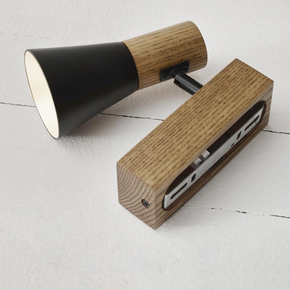 Wooden and black electronic devices on a light gray surface