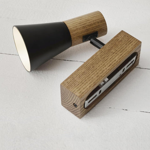 Wooden and black electronic devices on a light gray surface