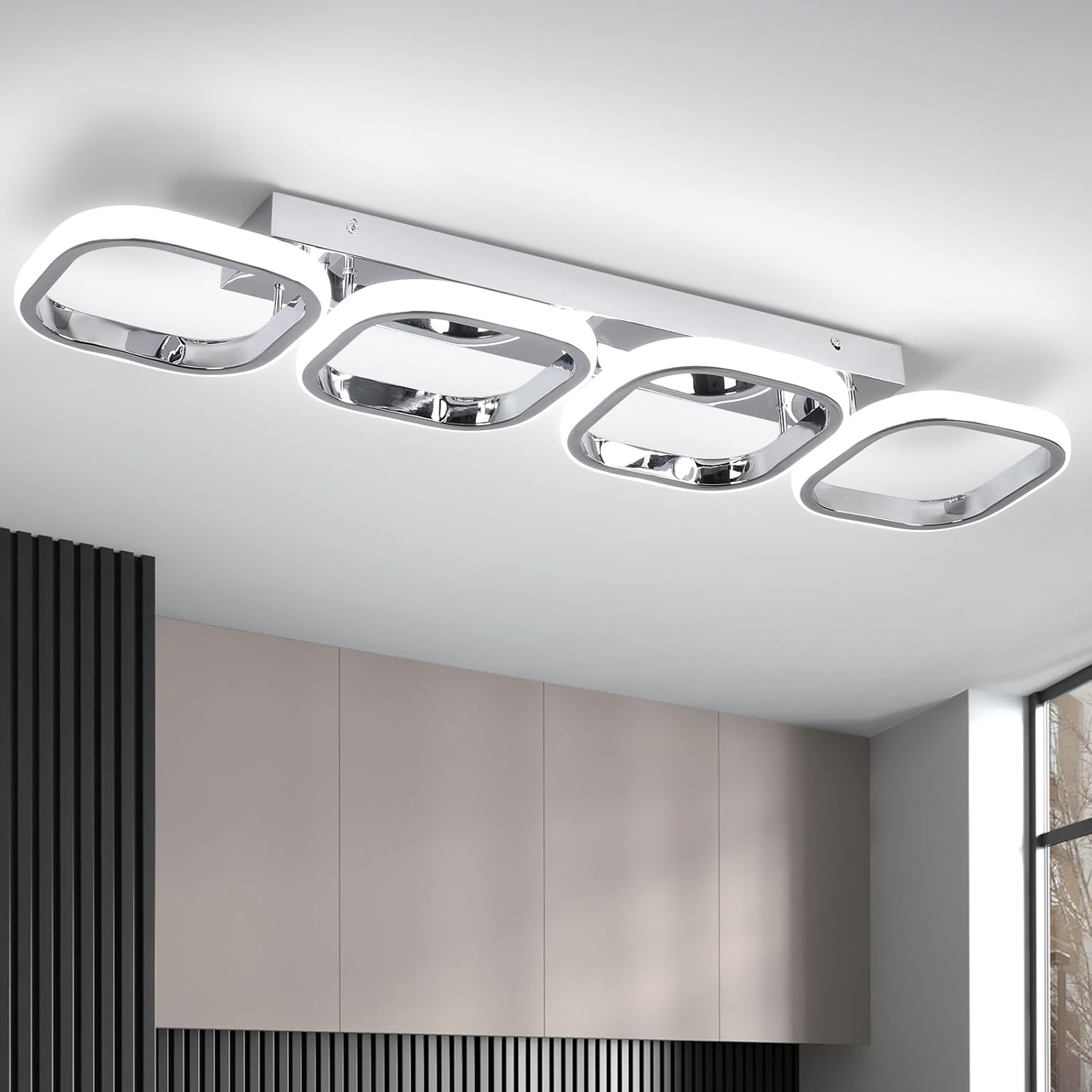 Modern ceiling light fixture in a room with neutral walls and a window.