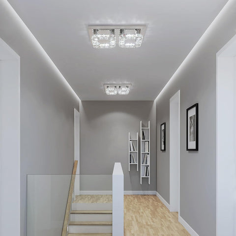 Modern hallway with ceiling lights, bookshelf, and framed pictures.