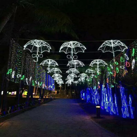 Decorative umbrella lights along a pathway at night