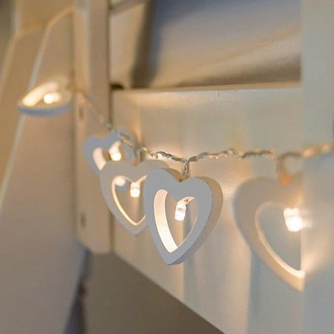 Romantic lighting setup with heart-shaped fairy lights for Valentine's Day.

