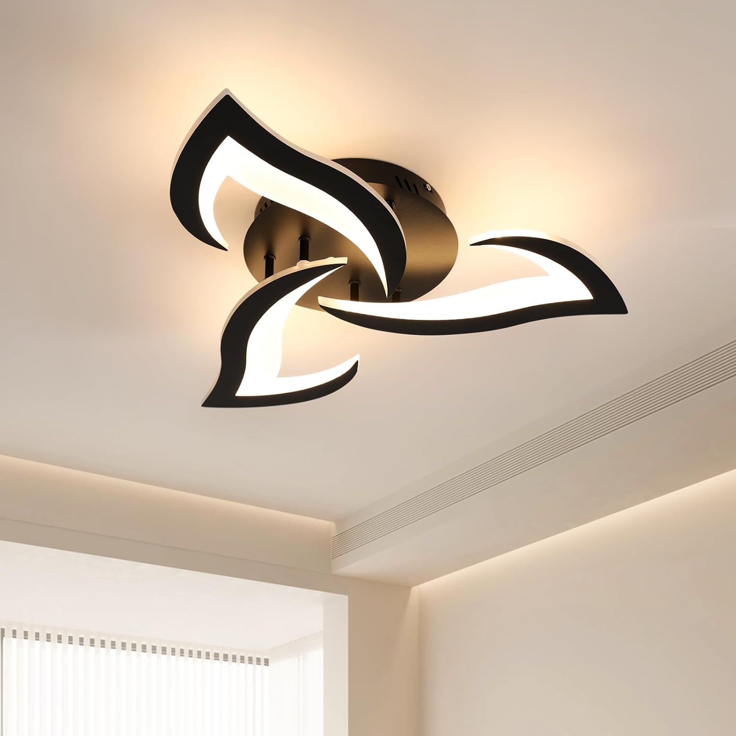 Modern ceiling light fixture with black and gold design on a ceiling