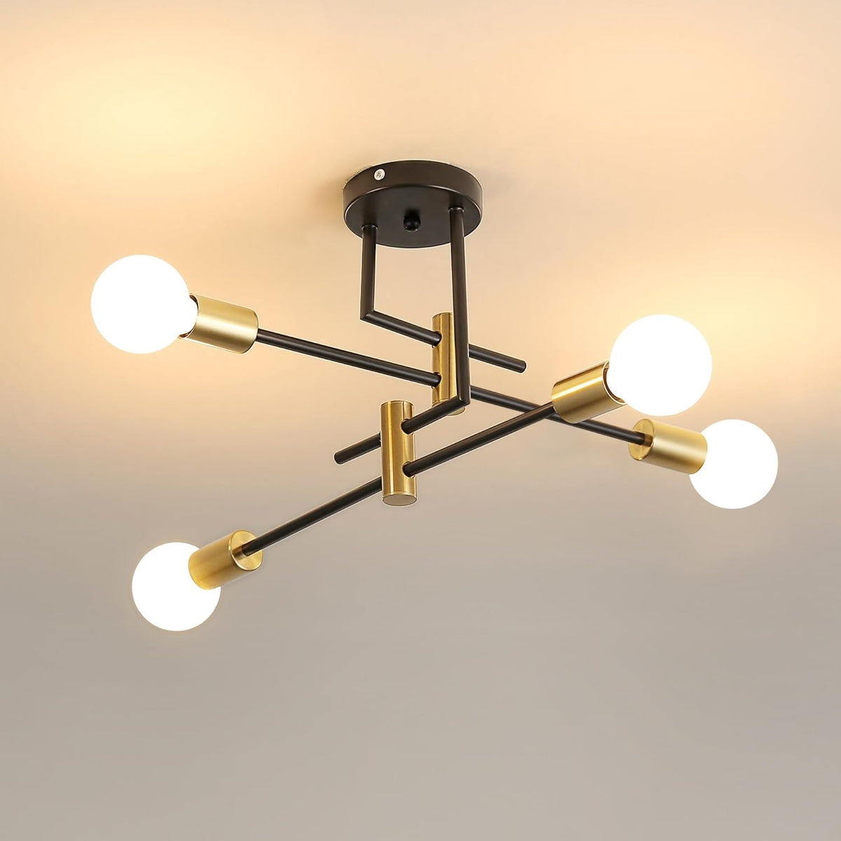 Modern ceiling light fixture with black and gold design on a neutral background