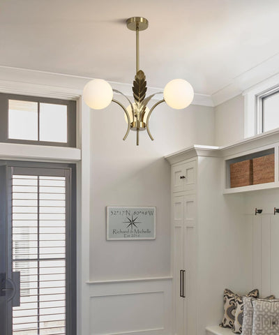 Modern chandelier in a room with white walls and a door.