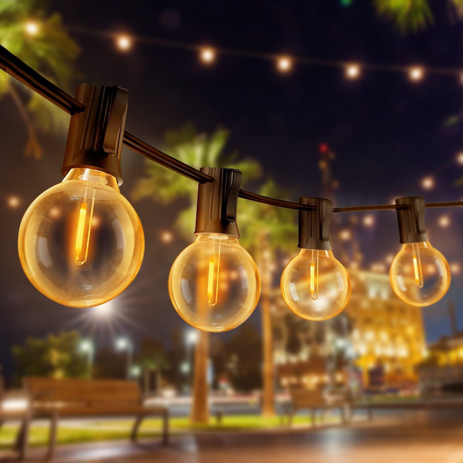 String lights with glowing bulbs in an outdoor setting at night.