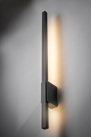Modern wall-mounted light fixture on a gray wall