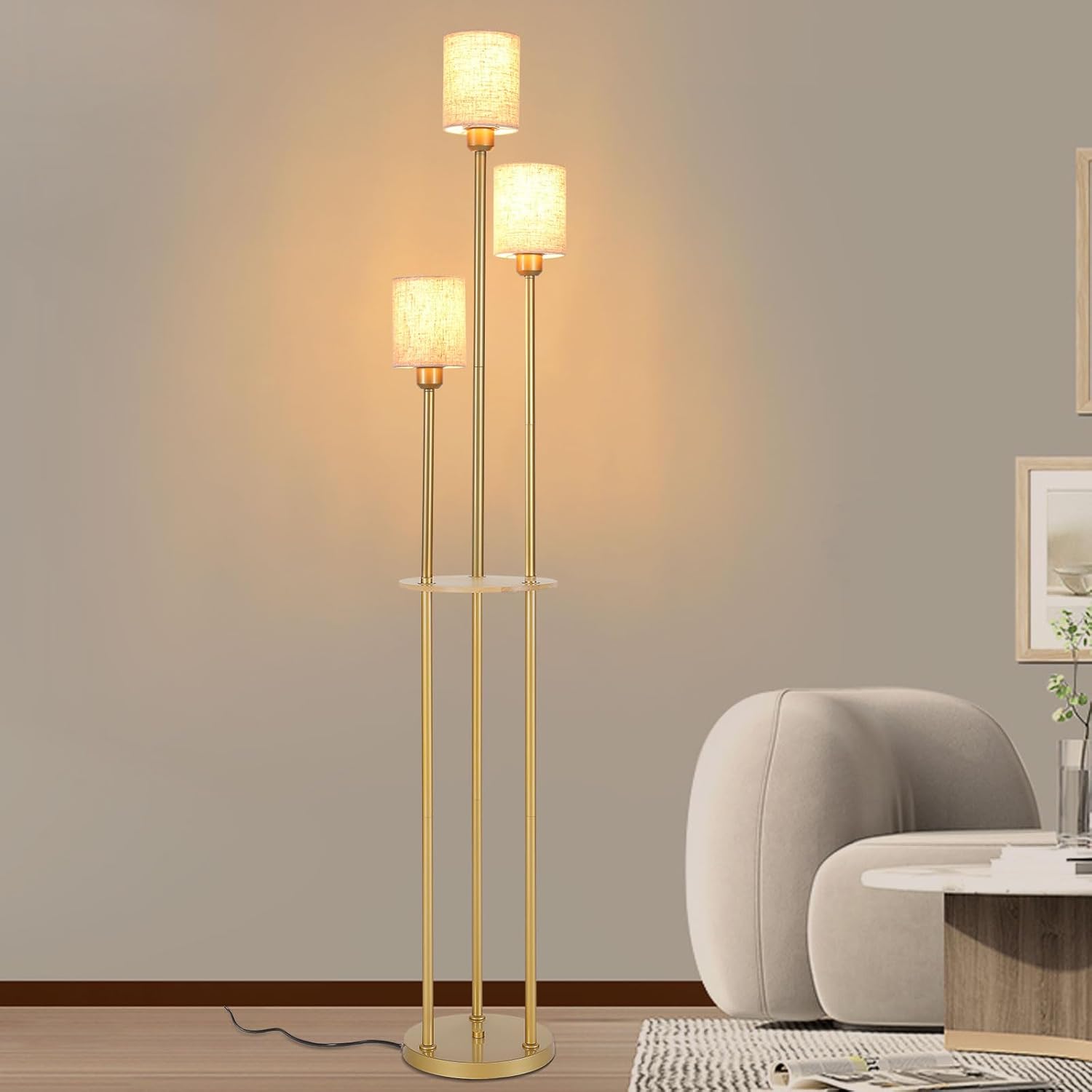 Gold floor lamp with two light bulbs in a room setting.