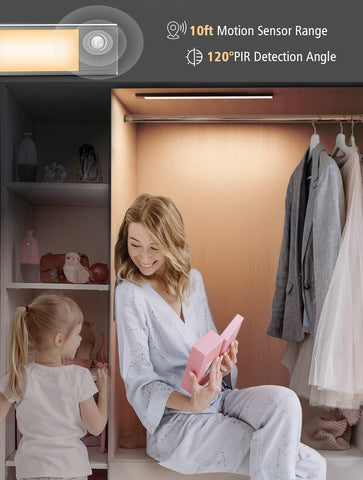 Woman and child in a closet with a motion sensor light above them.