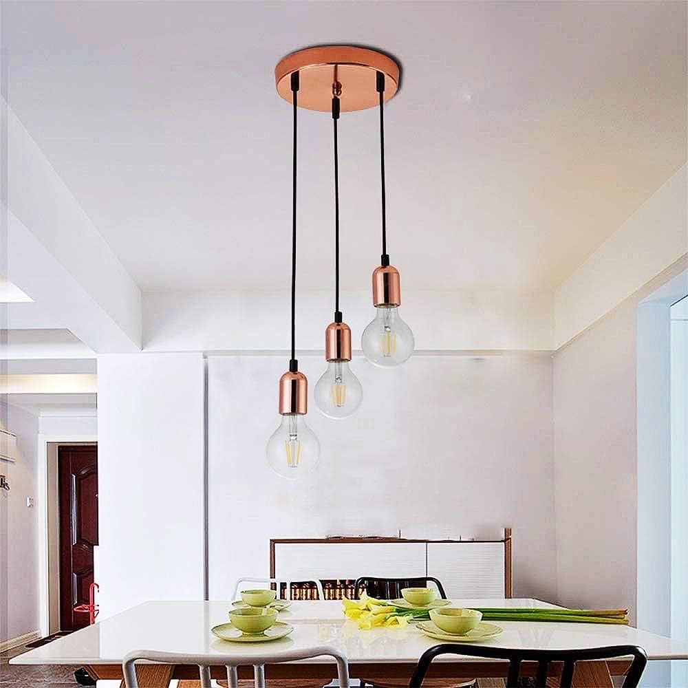 Modern pendant light fixture with glass bulbs in a dining room setting.