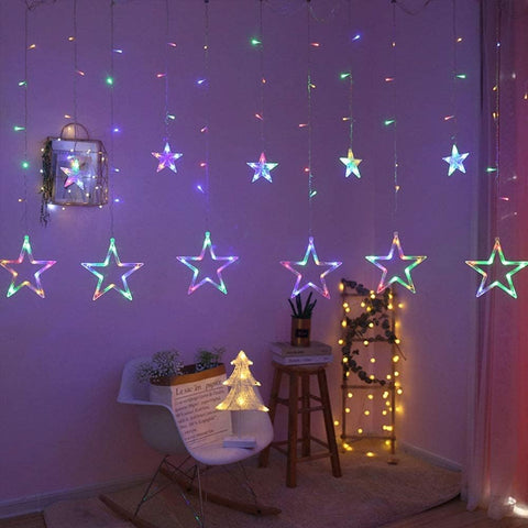 Room interior with star-shaped LED lights on a purple wall.
