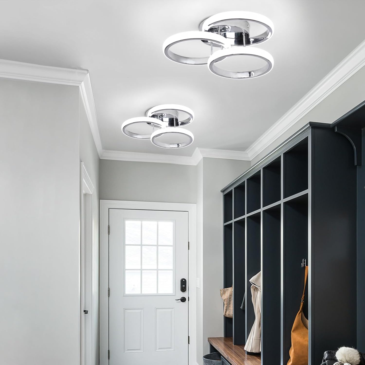 Modern ceiling lights in a hallway with a white door and black storage unit.