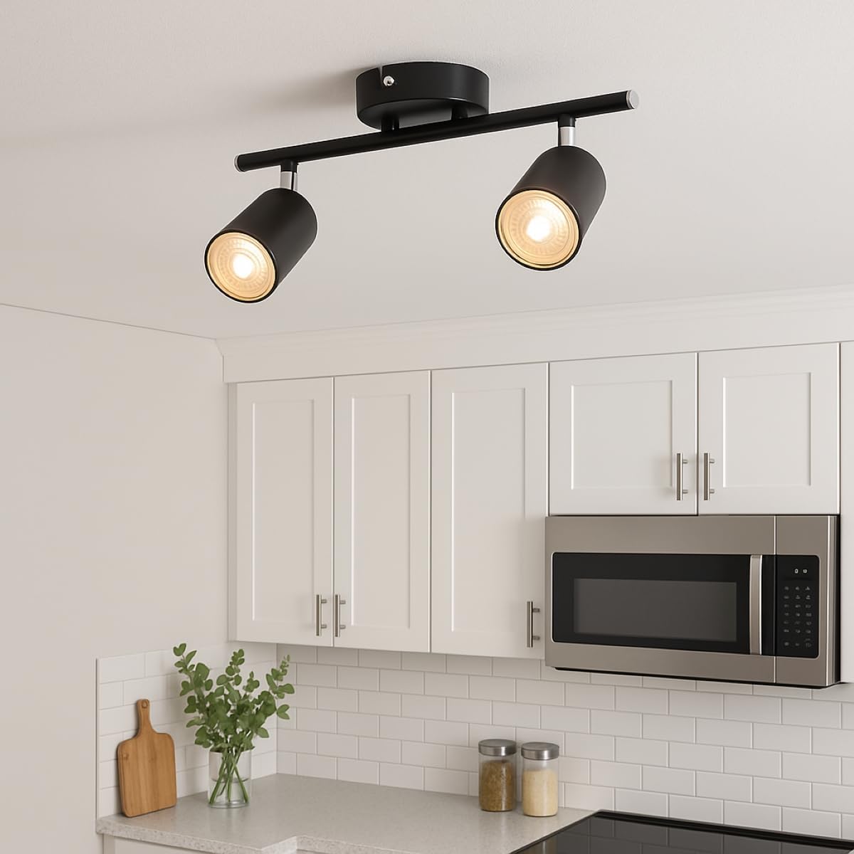 Black ceiling light fixture in a kitchen with white cabinets and a microwave.