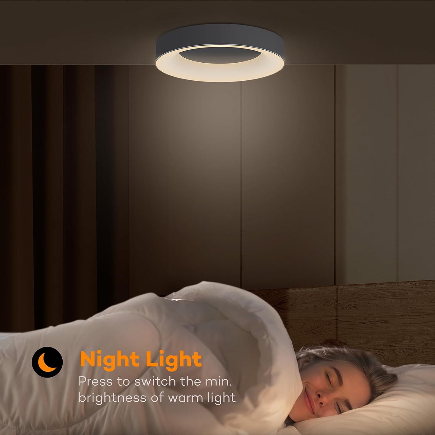 Person lying in bed with a night light above, in a bedroom setting.