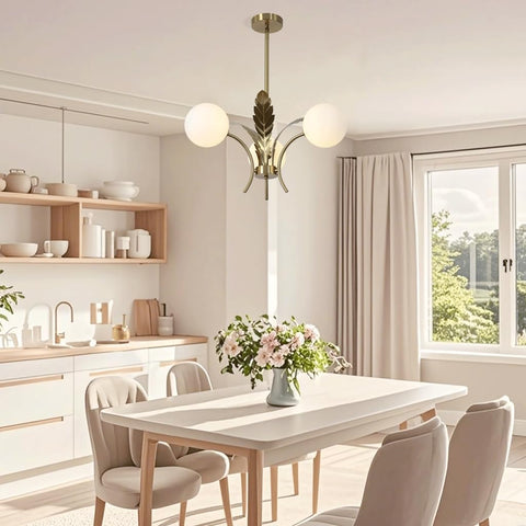 Modern kitchen with a dining table and chairs, featuring a chandelier and a window.