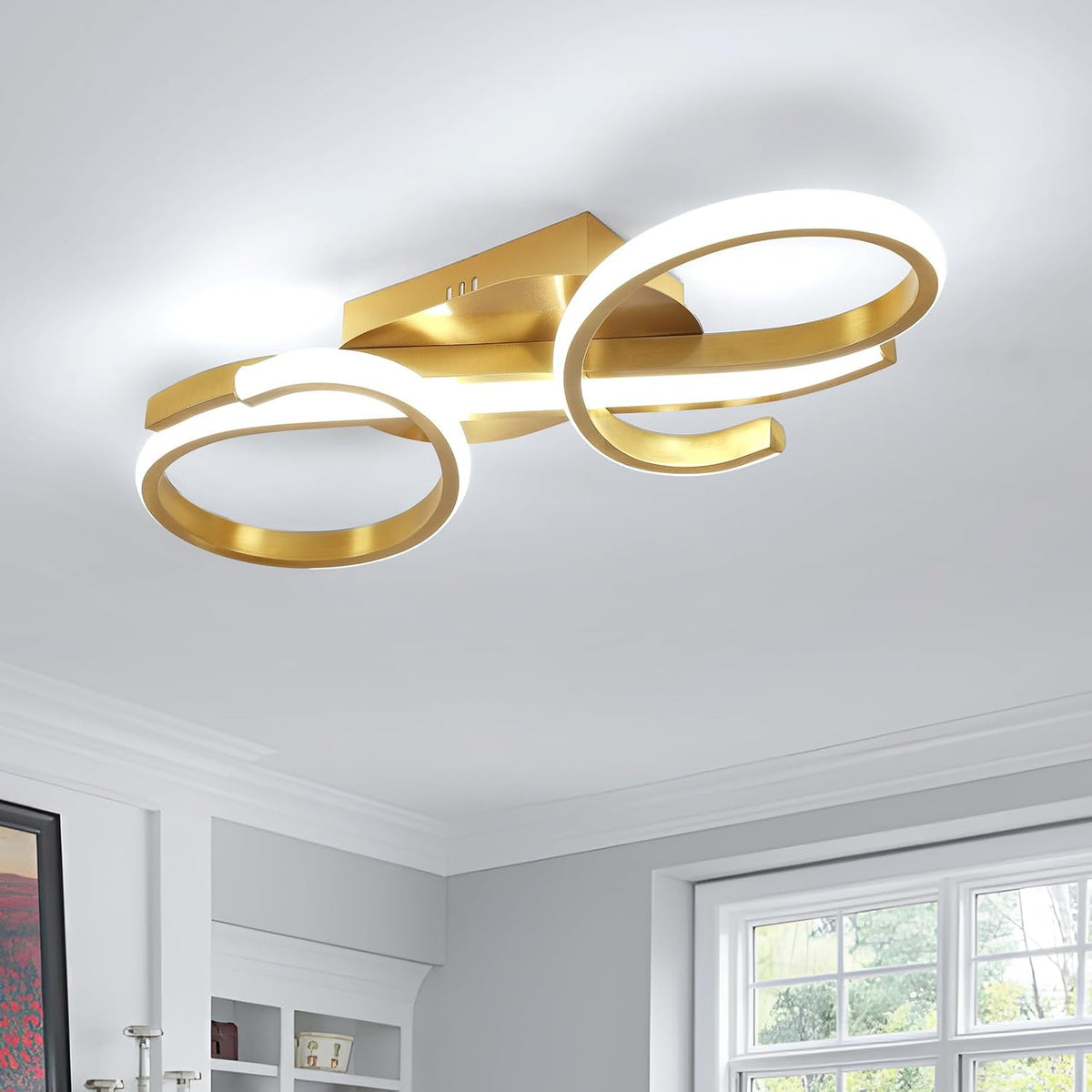 Gold ceiling light fixture in a room with a window and white walls