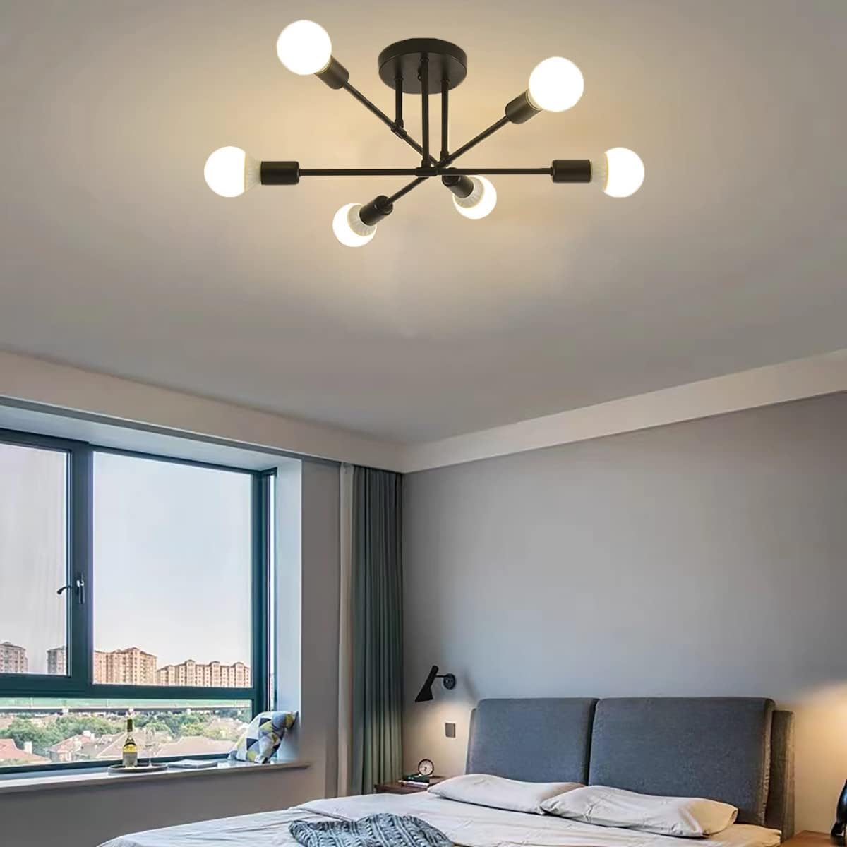 Modern chandelier in a bedroom with large window and bed.