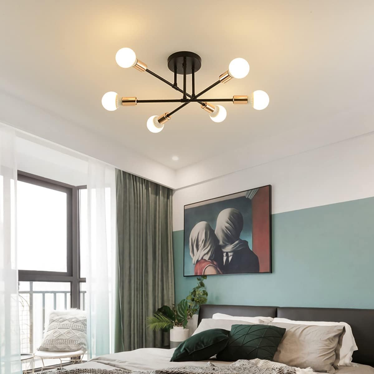 Modern ceiling light fixture in a bedroom with a bed and artwork on the wall.