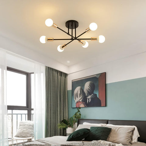 Modern ceiling light fixture in a bedroom with a bed and artwork on the wall.