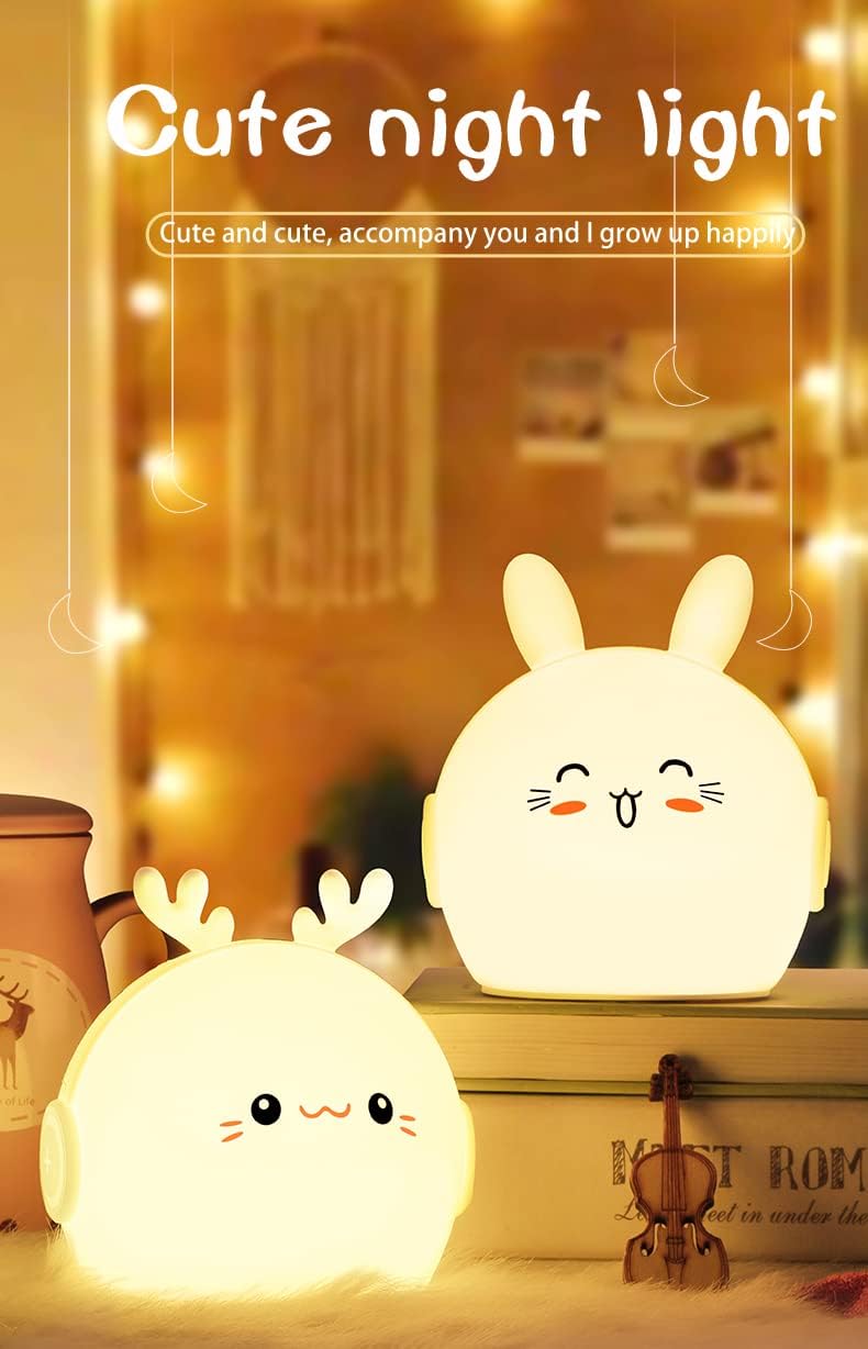 Two cute rabbit-shaped night lights on a surface with a blurred background.