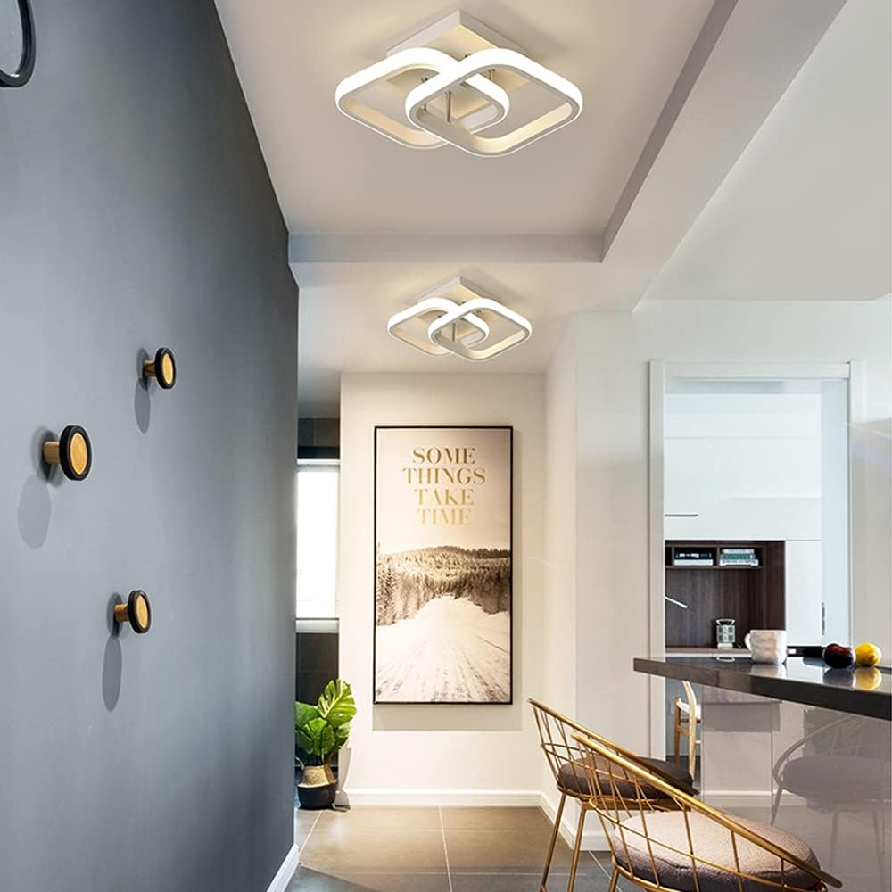 Modern interior design with ceiling lights, wall art, and a chair.