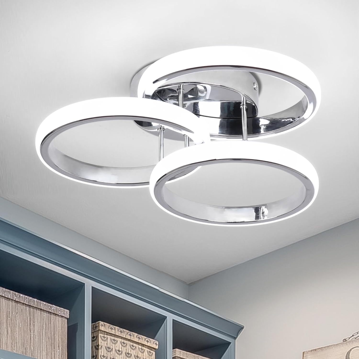 Modern ceiling light fixture in a room with shelves and books.