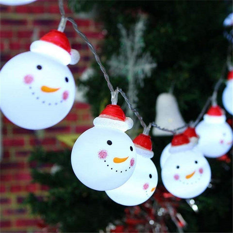 String lights shaped like snowmen with red hats on a Christmas tree.
