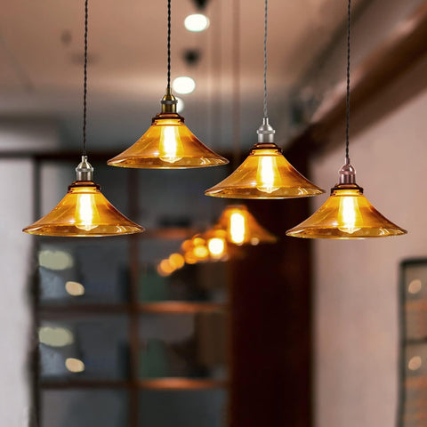 Gold pendant lights hanging in a room with blurred background