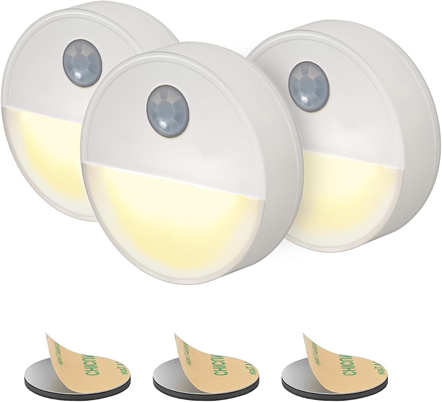 Three motion sensor lights with adhesive pads on a white background