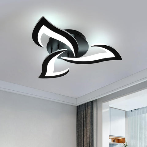 Modern ceiling light fixture in a room with white walls and a window.