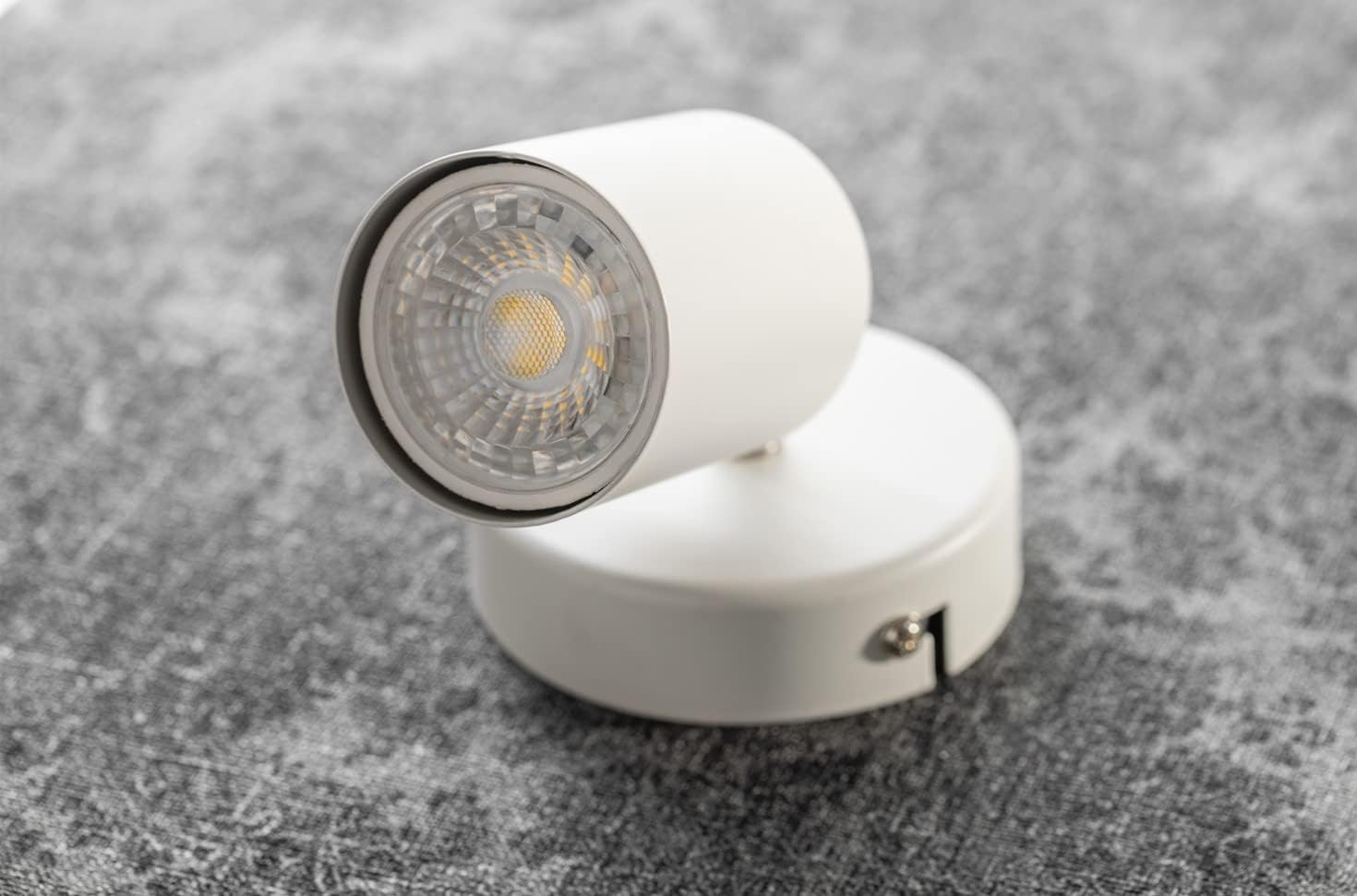 White spotlight on a textured gray surface