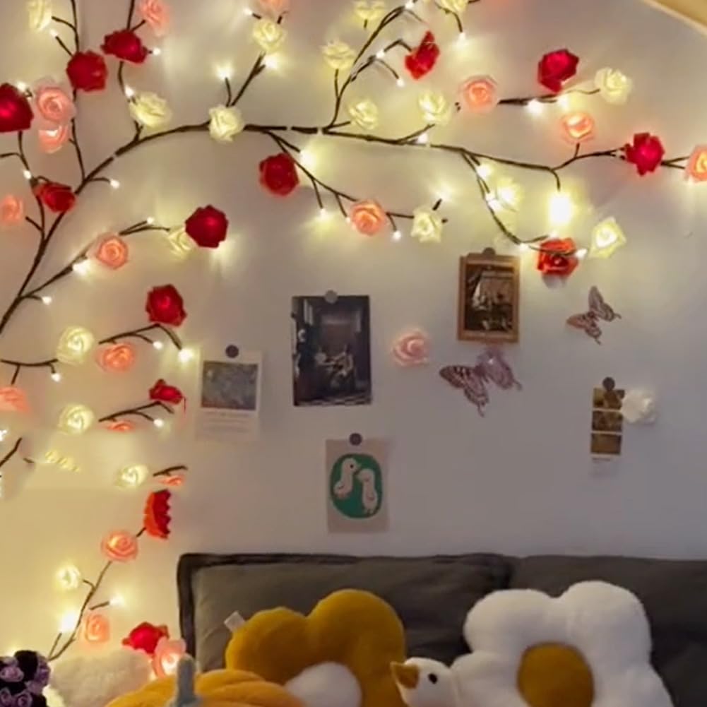 Decorative string lights with flowers on a wall above a couch with plush toys.