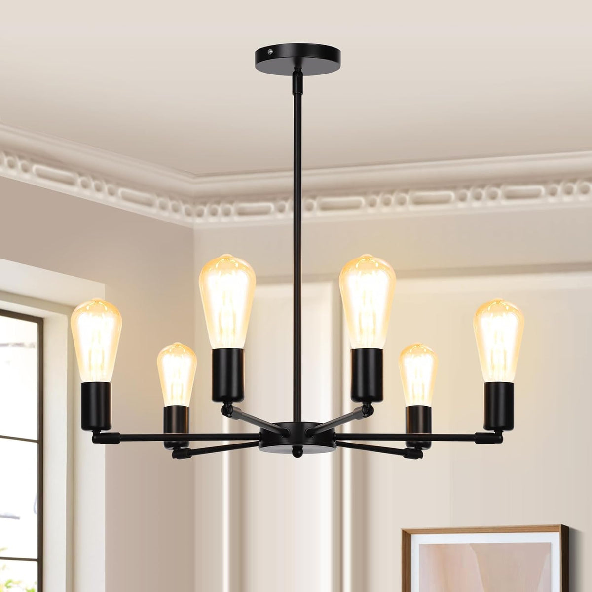 Modern chandelier with six light bulbs in a room with a window and framed picture.