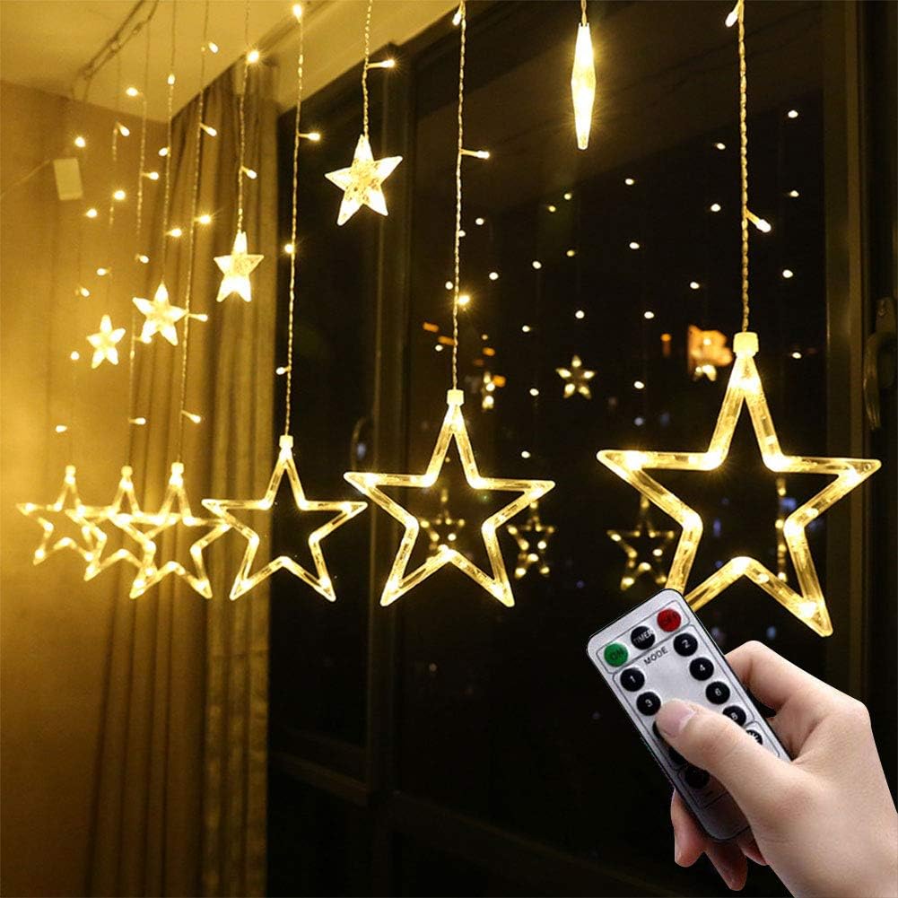 Star-shaped string lights hanging in a room with a remote control.