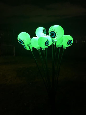Solar Powered Halloween Eyeball Garden Lights, 12-Piece Green LED Stake Set, IP65 Waterproof Outdoor Lawn and Pathway Decorations.
