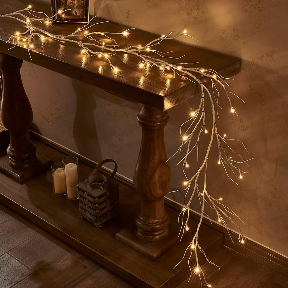 Decorative string lights on a wooden console table against a textured wall.