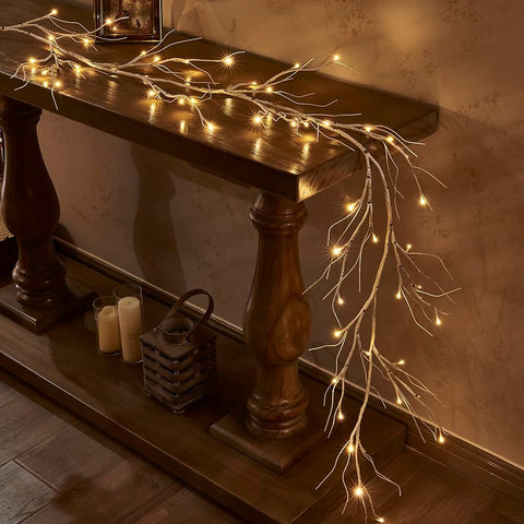 Decorative string lights on a wooden console table against a textured wall.