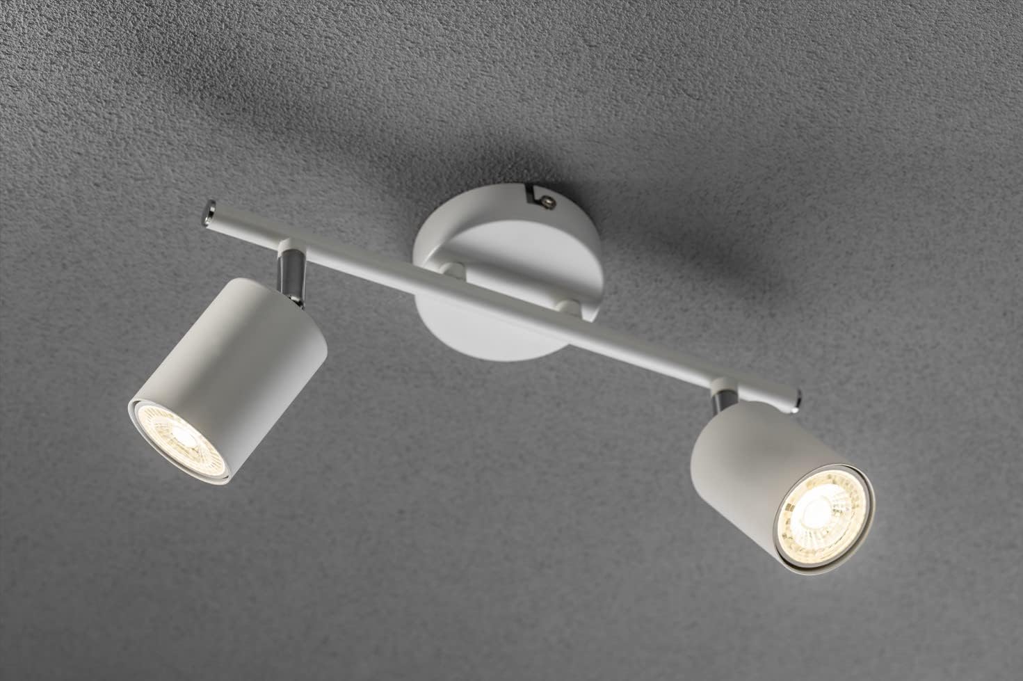 Modern ceiling light fixture with three adjustable lights on a gray background