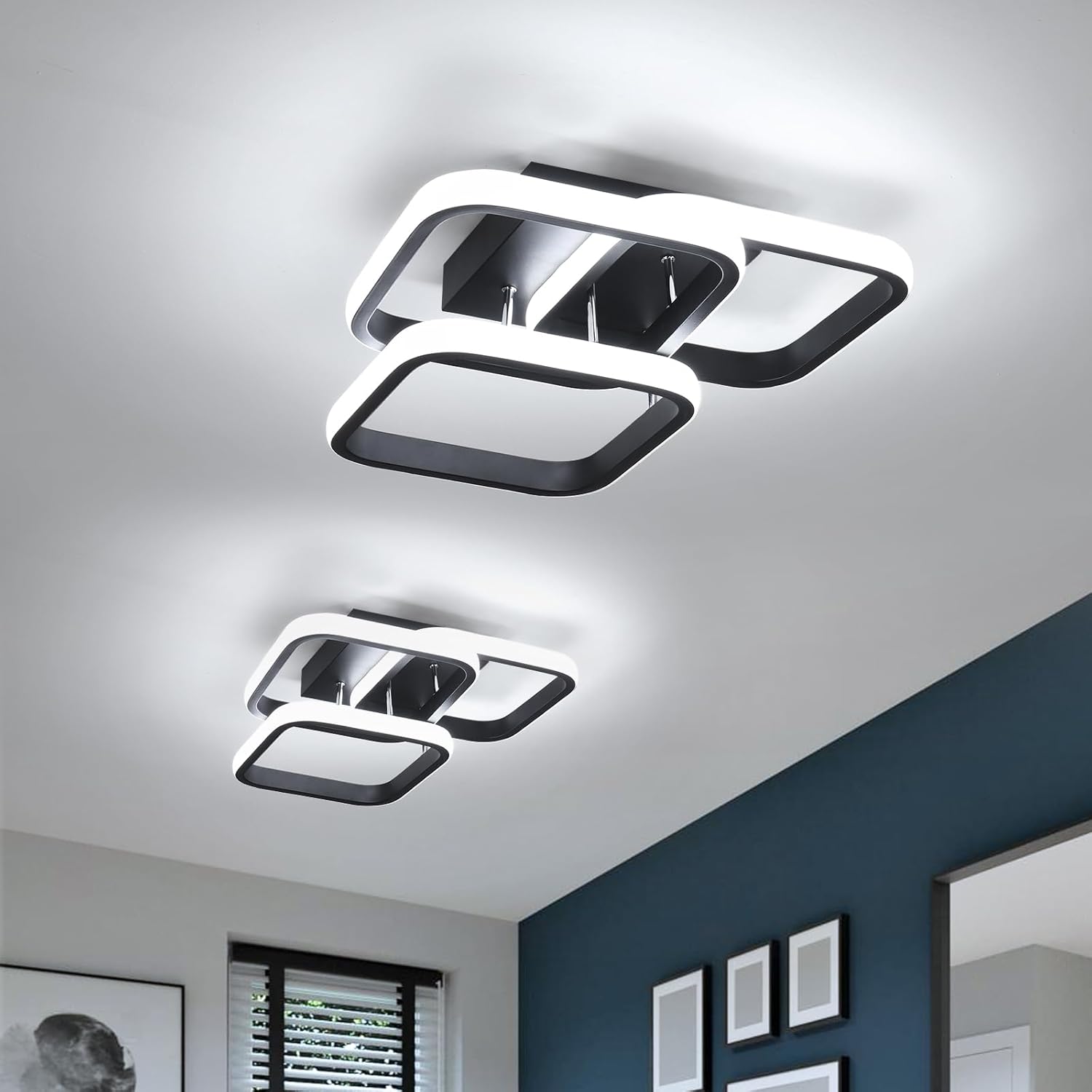 Modern ceiling lights in a room with blue walls and framed pictures.