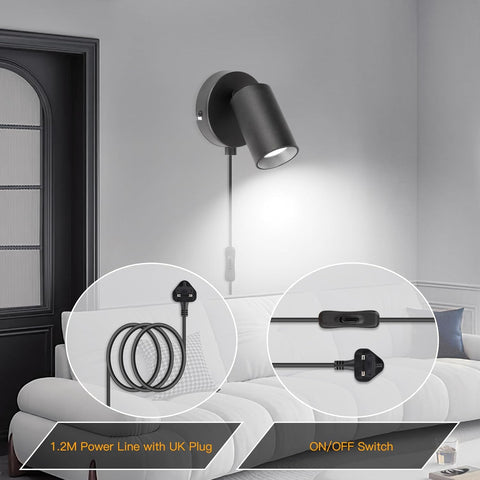 Wall-mounted black light fixture with power cord and on/off switch in a living room setting.