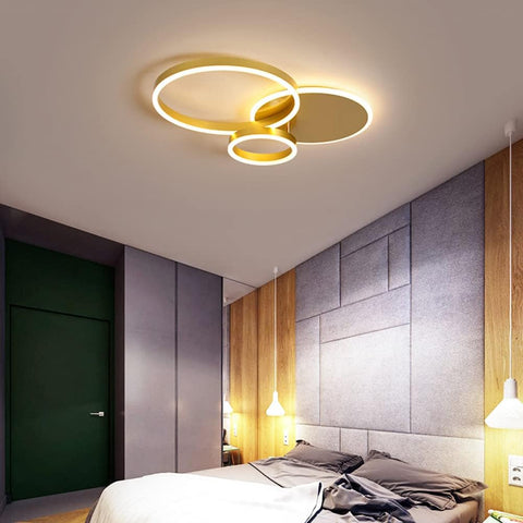 Modern bedroom with a ceiling light fixture and gray wall.